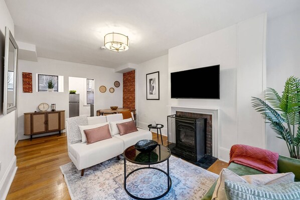 View of the smart TV and 2 sleeper chairs