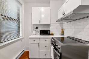 Kitchen with microwave and stove with oven
