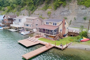 Nestled at the edge of a serene lake, this charming dock features a row of inviting, comfortable chairs, perfect for relaxing and enjoying the peaceful surroundings. The chairs, crafted from weather-resistant materials, are designed for comfort with