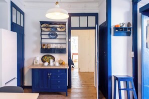 Santo Antonio 2 charming, cozy kitchen with rich navy blue cabinetry and vintage accents.
