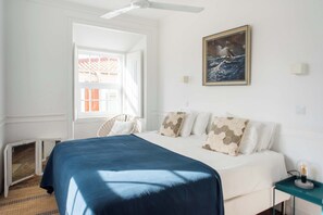 Santo Antonio 2 bedroom, bathed in natural light, coastal-inspired decor, with a calming color palette.