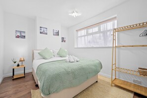 A comfortable king-size bed for a restful night's sleep, plus a hanging space to keep your belongings organized and easily accessible.