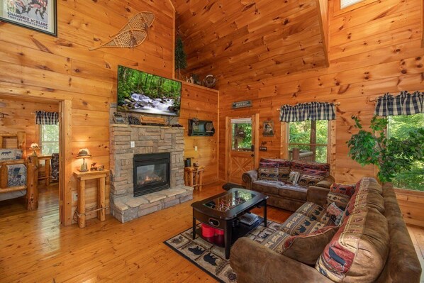 Open-concept living area featuring a double-sided gas fireplace, viewable from the sofa or the king master suite.