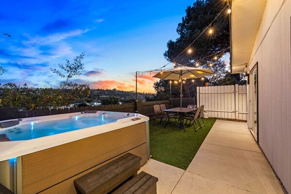 Unwind under the stars! Enjoy a peaceful evening in our private hot tub and cozy outdoor dining area, perfect for relaxing after a day of adventure.