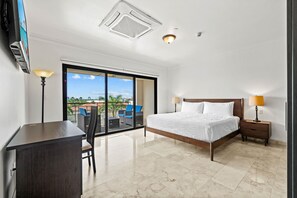 - Bright and airy bedroom with a comfortable king-sized bed and minimalist furnishings - Sliding glass doors open to a private balcony, offering stunning views and fresh air - The simple yet sophisticated design emphasizes relaxation and tranquility