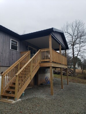 Back porch with stairs leading to fire pit