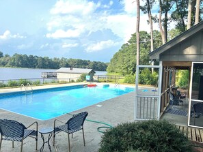 Large lakeside pool with pool house. Pool house has a fridge, & full bathroom.