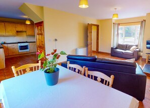 Seacliff Holiday Home No. 12. Dunmore East, County Waterford, Ireland. Dining table, open plan living room.