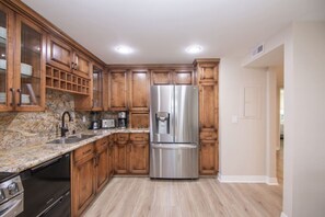 Modern kitchen equipped with top-of-the-line appliances, marble countertops, and all your cooking essentials.
