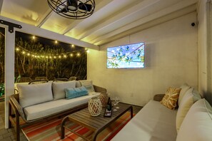 Enjoy the ultimate backyard retreat with a hot tub, corn hole, covered patio, BBQ, and fire pit for endless relaxation and fun.