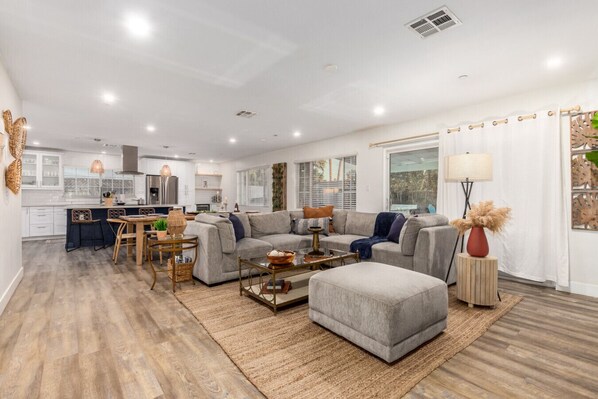 Relax in the spacious living room with a comfortable sofa, perfect for unwinding after a day of exploration.