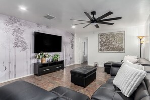 Cozy living room with plush seating and a smart TV for ultimate relaxation.