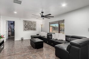 Cozy living room with plush seating and a smart TV for ultimate relaxation.