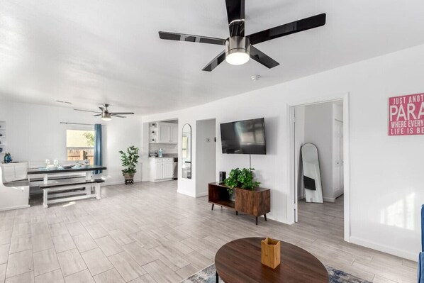 Relax in the spacious living room with comfy seating and a smart TV for entertainment.