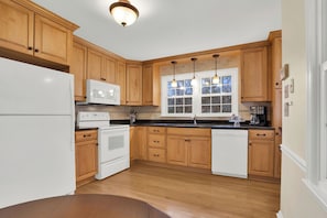 Spacious, fully stocked kitchen includes lots of counter space to cook meals in