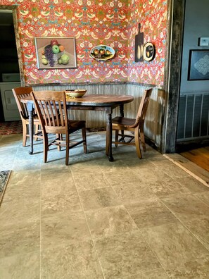 Eat in kitchen with old vintage table. Wallpaper from arts & crafts period.