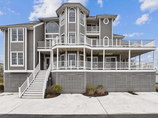 This stunning luxury beach house features expansive decks and vaulted ceilings, perfectly positioned to offer scenic waterfront views.