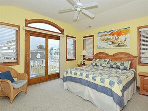 Bright and cozy bedroom with a private balcony and plenty of natural light, perfect for a peaceful retreat.