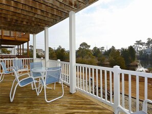 Spacious balcony with outdoor seating, offering serene views of the surrounding area.