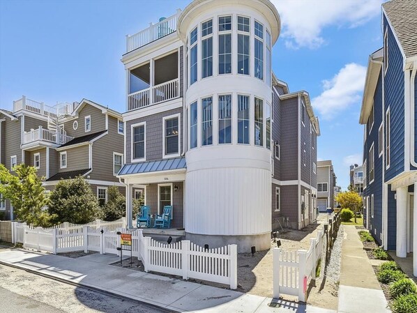 Stunning exterior with a classic beach cottage design, located just 30 yards from beach access, perfect for a seaside retreat.