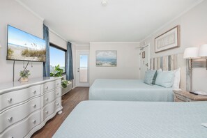 Bright bedroom with two inviting beds, and  modern furnishings 