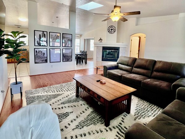 The home's open floor plan seamlessly connects the kitchen, living room, and dining room, creating a spacious and airy feel perfect for entertaining and spending time together.