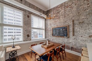 Beautiful, exposed brick walls tell of this building's rich history. The open concept dining area offers seating for 6 at the table