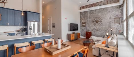 The open concept great room with downtown views, exposed brick walls, 20ft ceilings, natural light and the comforts of home all await you at #501
