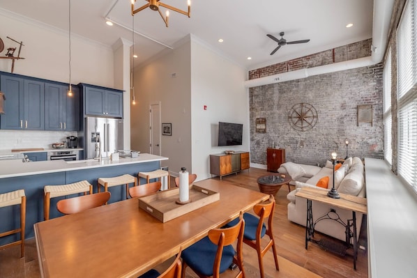 The open concept great room with downtown views, exposed brick walls, 20ft ceilings, natural light and the comforts of home all await you at #501