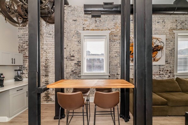 View of the dining area between the coffee bar and living space