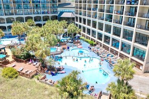 Luxurious beachside resort with a sparkling pool, relaxing hot tubs, and a lively poolside bar. Surrounded by palm trees and overlooking the ocean, this tropical oasis offers sun loungers, refreshing drinks, and direct beach access for max relax.