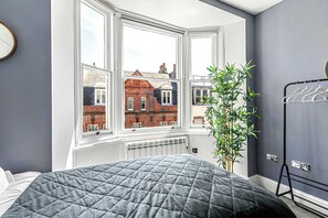 Cozy room with twin beds and a touch of greenery