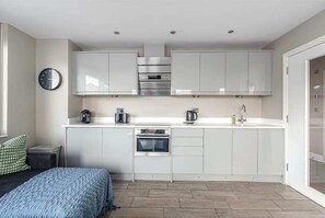 Modern kitchen fully equipped with everything you need—including a coffee machine—for a convenient and comfortable stay.