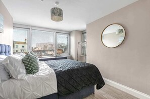 Bright and stylish bedroom with a comfy bed, soft linens, and a peaceful vibe—perfect for a restful night’s sleep.