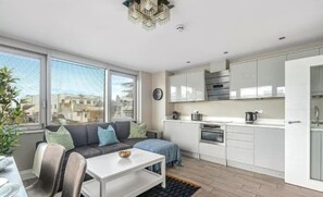 Contemporary city apartment with sleek kitchen, large windows, and open-plan comfort