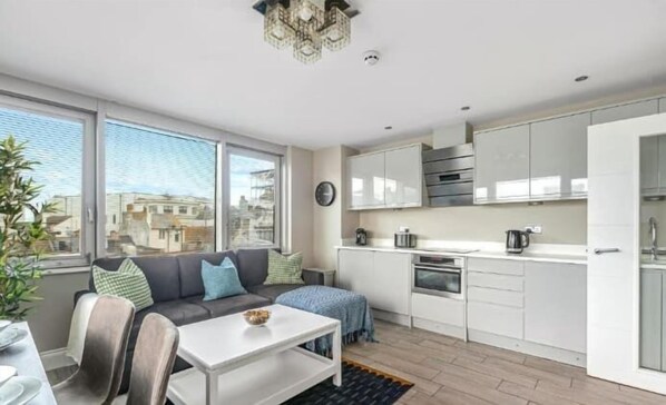 Contemporary city apartment with sleek kitchen, large windows, and open-plan comfort