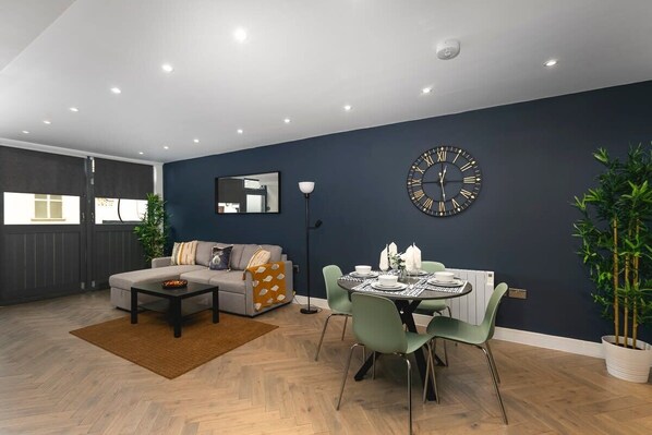 Open-plan living and dining area with stylish dark accents