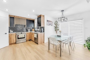 Bright dining area seamlessly connected to an open kitchen, perfect for entertaining and family meals.