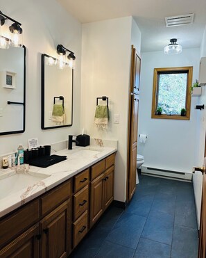 Main level bathroom. Completely renovated with new tops, tile and shower.