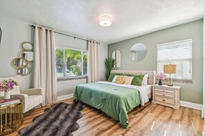 Luxury master bedroom in Clearwater with sage green accents, designer mirrors and plush king bed perfect for bachelorette stays