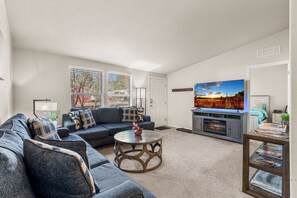 Large sectional with bright windows and comfy vibes