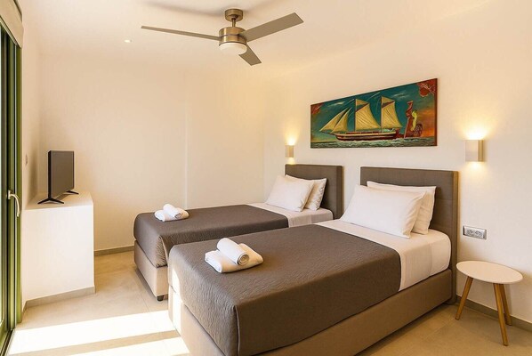 Living Room – Bright and Airy Interior Space
Comfortable layout with modern furniture, ceiling fan, and natural light.