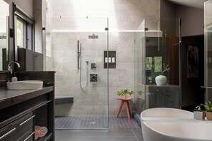Primary en suite bathroom with stand-alone soaking tub and large shower