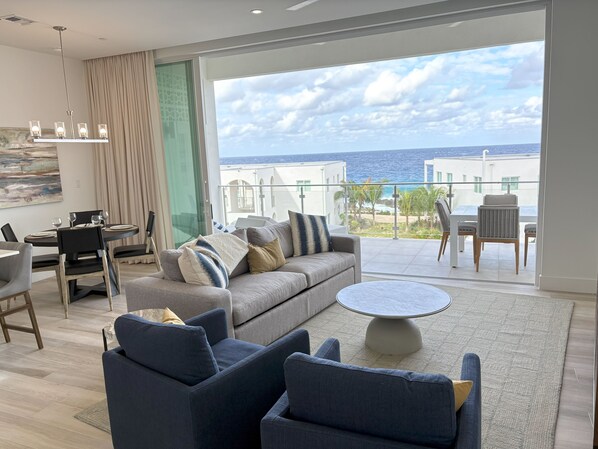 Living area with floor to ceiling sliding doors. 