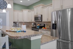 Well appointed kitchen with granite countertops & stainless appliances.