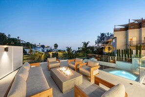 Experience warmth and elegance with a sleek fire pit centerpiece.