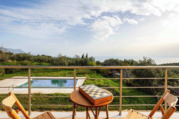Panoramic views from the balcony – Mountains, olive groves, and sky

