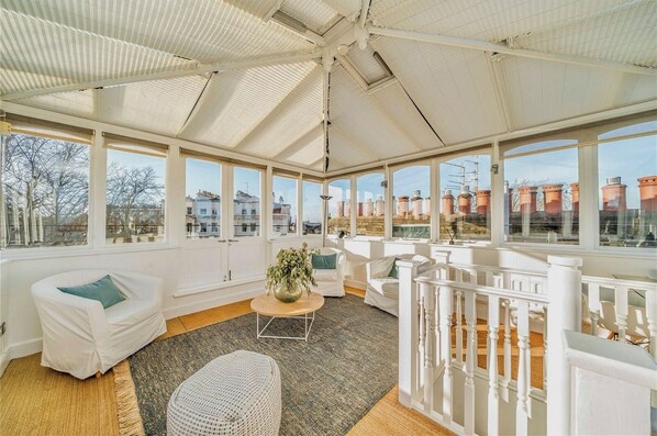 Conservatory, seating area and a small workspace, leading to the roof terrace.