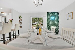 Dining table overlooking the backyard patio + LED plant photo backdrop