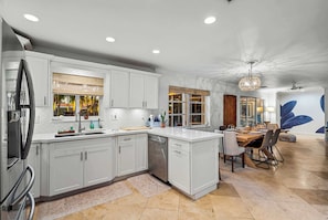 The dining table is conveniently located next to the kitchen